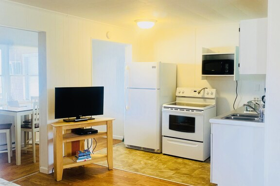 a kitchen with an island in the middle of a living room