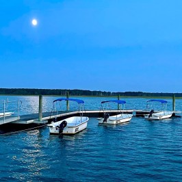 a boat is docked next to a body of water