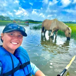 a person standing next to a body of water