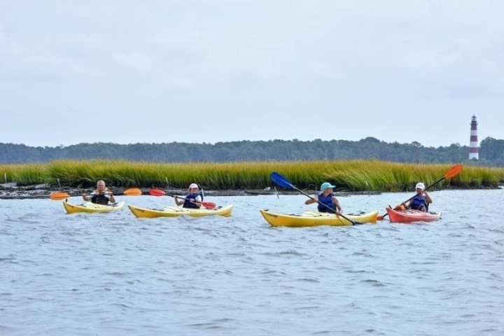a group of people in a small boat in a body of water