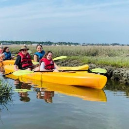 a group of people on a raft in a body of water