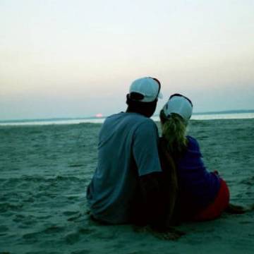 a man standing next to a body of water