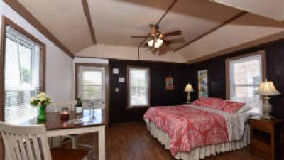 a bedroom with a bed and a chair in a room