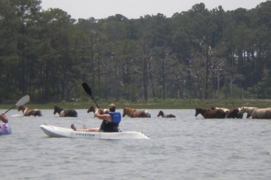 a group of people in a boat on a body of water