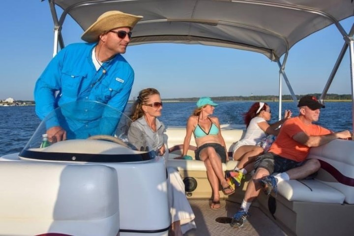 a group of people riding on the back of a boat