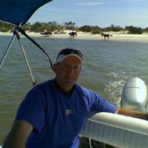 a man standing next to a body of water