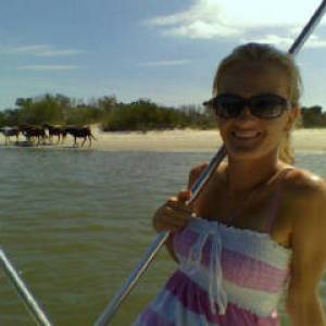 a person standing next to a body of water