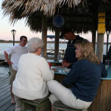 a group of people standing around a table